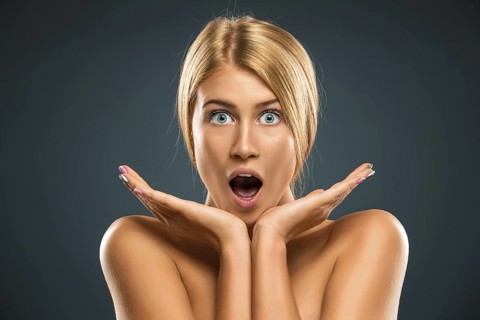 Portrait beautiful blond woman with blue eyes stared into the camera - isolated azure background