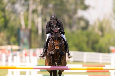 Kyle King of the United States and riding Odysseus, compete in the 1.60m Grand Prix during The