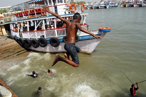 Children jumping and swimming into the Arabian Sea at Gateway of India, Bombay now Mumbai,