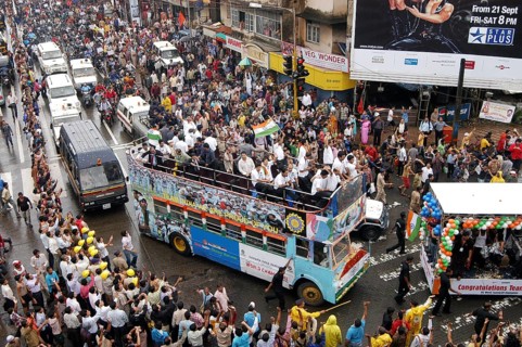 Twenty 20 team wave tri color Indian flags in special decorated bus during victory procession,