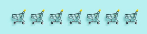 Shopping cart in row on blue background. Minimalism style. Toy trolley for supermarket. Top view or