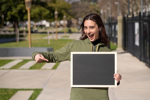 Woman holding a black poster without text. Business template concept