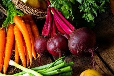 Basket with various vegetables: beetroot and carrots