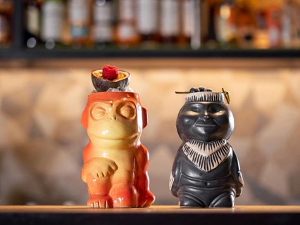 Tiki Drink Cocktails. Two tropical tiki cocktails on bar counter. Tiki cocktails on bar in night