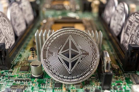 Ethereum coin close-up on a computer circuit motherboard as a blockchain technology payment network
