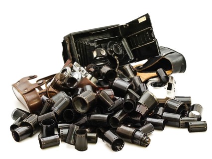 Retro Photo Accessory With Many Films And Vintage Cameras Against The White Background Daugavpils,