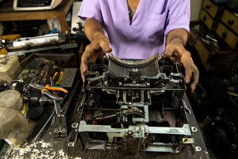 Technician repairing an old manual typewriter Mumbai, Maharashtra, India, Asia