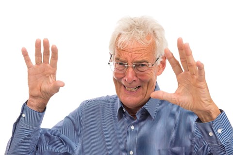 Portrait scaring senior man isolated against white background
