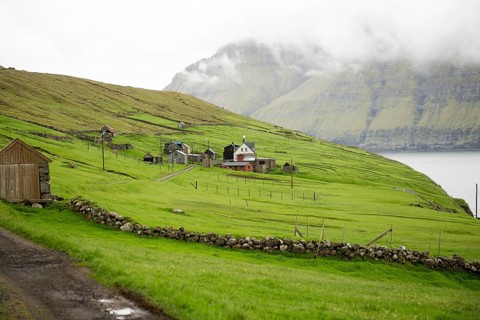 The village Muli on the Faroe Islands with green grass and few houses, Muli, Faroe Islands