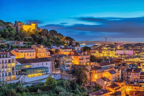Lisbon Portugal sunset city skyline at Lisbon Baixa district and Saint George Castle