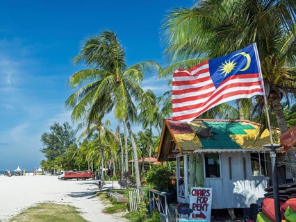 Beach hut with flag, on the sandy beach, Chenang Beach, Langkawi, Kedah State, Malaysia, Southeast