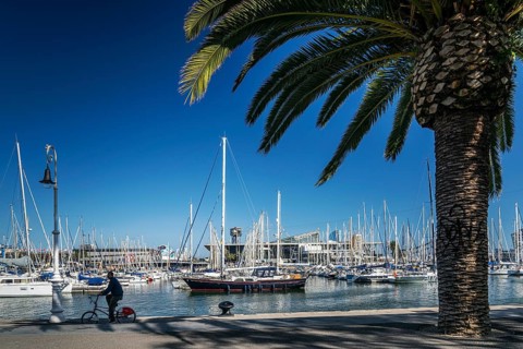 Urban marina view and pedestrian promenade in port vell area of barcelona spain