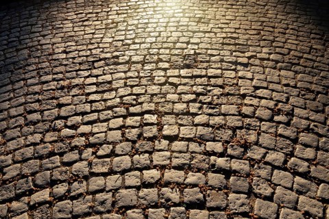 Gloomy old cobblestone pavement. Beautiful natural background