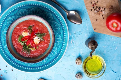 Classic spanish raw eating cold soup Gazpacho served at blue table. flat lay. food recipe. healthy