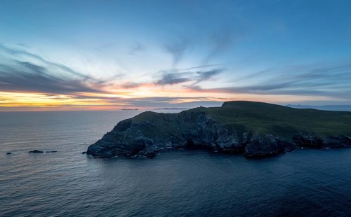 Sunset over the Atlantic Ocean and the cliffs of Bray Head on Valentia Island in County Kerry of