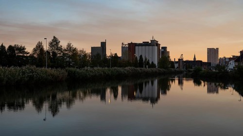 Wilsele, Flemish Brabant, Belgium, Reflection of industrial buildings in the canal during sunset