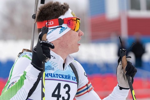 Portrait Russian sportsman biathlete Zlobin Vladislav Khanty-Mansiysk at finish after rifle
