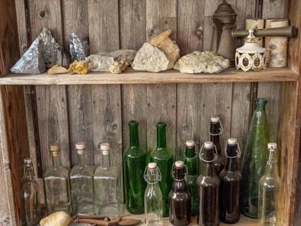 Shelves with bottles and stones on a rustic wooden wall, antique atmosphere, borken, münsterland,