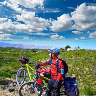 Cycling tourist MTB cyclist in Pedralba Valencia with paniers and saddlebag Spain