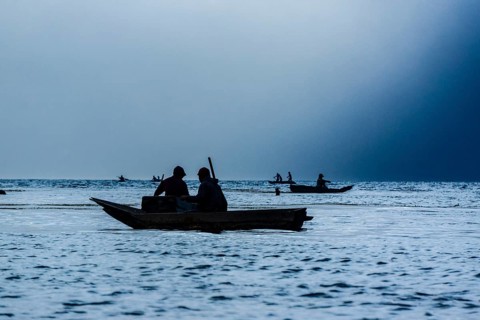 Tourists on a mooring enjoying the sunset, Lake Atitlan and San Pedro volcano, Santiago Atitlan,