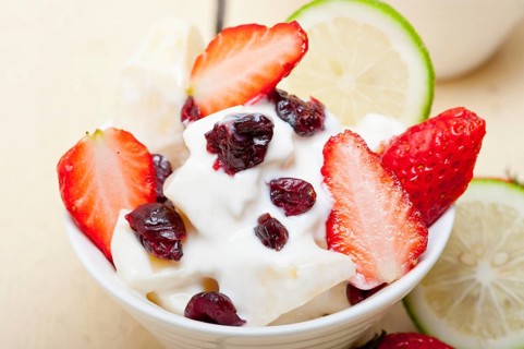 Fruit and yogurt salad healthy breakfast over white wood table, Food photography, Food photography