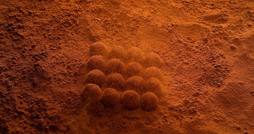 Chocolate Powder falling on Chocolate Truffles
