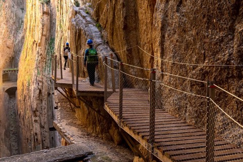 El Chorro, Spain - 22 February, 2022: tourists enjoy hiking the Camino del Rey on a bautiful winter