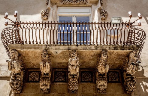 Noto town in Sicily, the Baroque Wonder - UNESCO Heritage Site. Detail of Palazzo Nicolaci balcony,