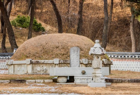 Chungju, South Korea, December 18, 2018: Burial mound surrounded by concrete wall and small statues