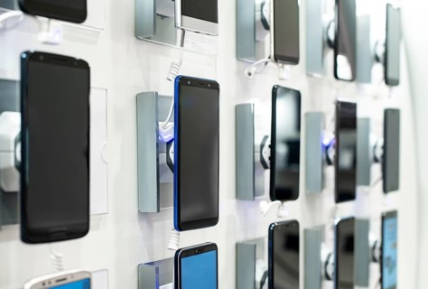 Smartphones on shelf in the store. Concept for communications and technology. Buying mobile phone