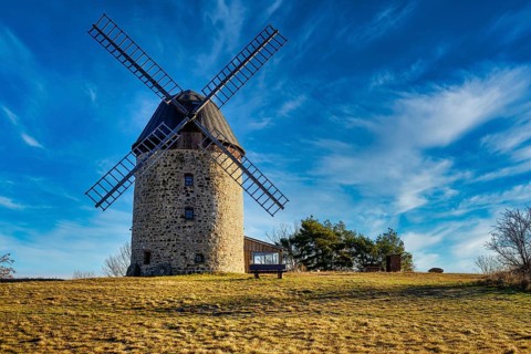 A windmill in the field in the daytime