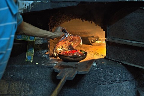 A community oven in the town of Tanger, which is used by a local and who is preparing some meal