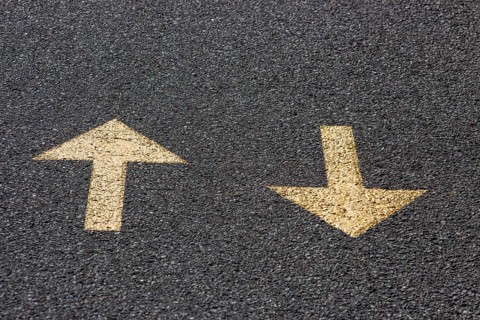 Yellow arrows on the asphalt road, back and forth