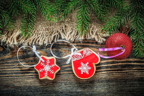 Pine tree branches bagging Christmas ball gingerbread on wood board