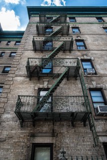 Traditional fire escape ladders at the facade of a New York's apartment, USA