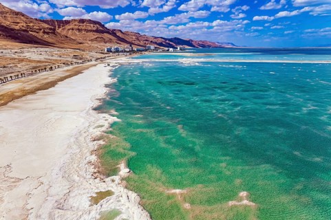Magnificent Dead Sea. Drone footage. Bright March day. The water reflects the bright blue of the