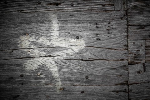 White star painted on the old cracked wood with worn-out paint. Grunge look