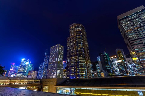 Aerial view of Hong Kong skyscrapers in Central District at night in Hong Kong island