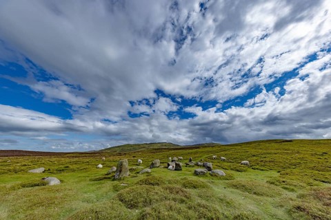 Druids Circle, stone circle in wide landscape with pastures in the mountains, Penmaenmawr,