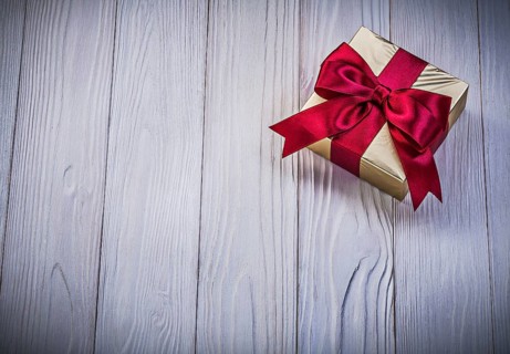 Wrapped giftbox on wooden board holidays concept