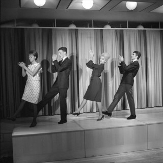 Dancing in the 1960s. The dance Hully Gully is being made popular and here are men and women