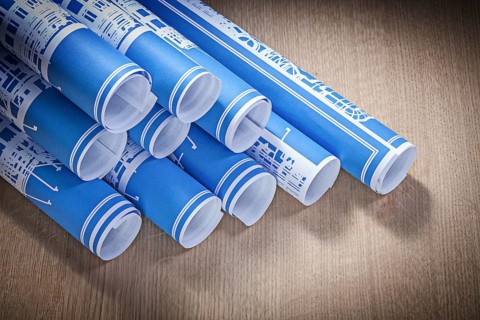 Blue engineering drawings on wooden board construction concept