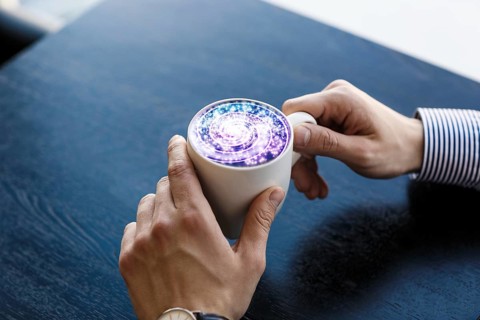 Coffee cup with cosmos space on wooden table