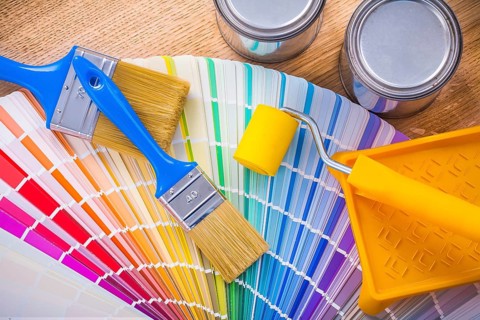 Set of painting tools paint brush roller tray can color palette on wooden desk