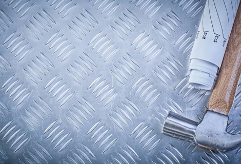 Claw hammer blueprints on grooved metal sheet copy space construction concept