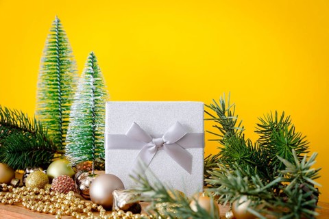 A Christmas decoration glass balls with fir trees on yellow background
