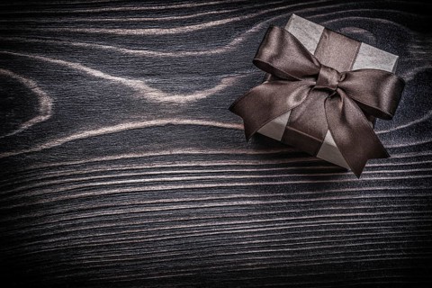 Present box on wooden board holidays concept