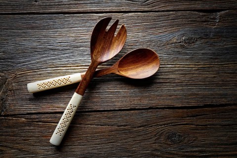 Wooden kitchen tools spatules spoon and fork kitchenware on wooden background