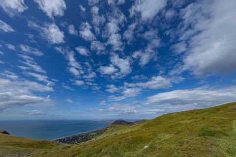 Vast rolling countryside with green meadows and sea views on the edge of Snowdonia National Park,
