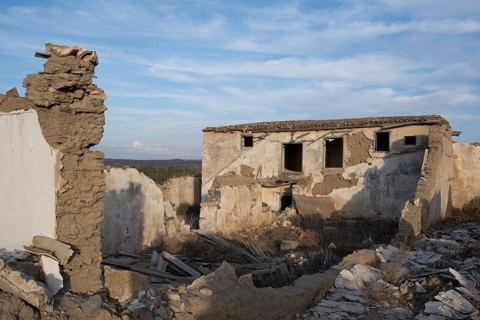 Abandoned and collapsing farm house outdoor. Clay traditional architecture ruins. Deserted places